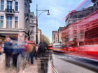 long exposure blurred shot of people and buses on oxford street, London